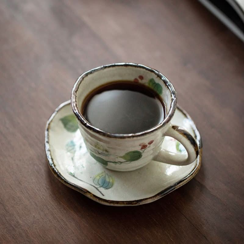 Mino-Yaki Ceramic Grape Vine Coffee Set Cup filled with coffee on a wooden table.